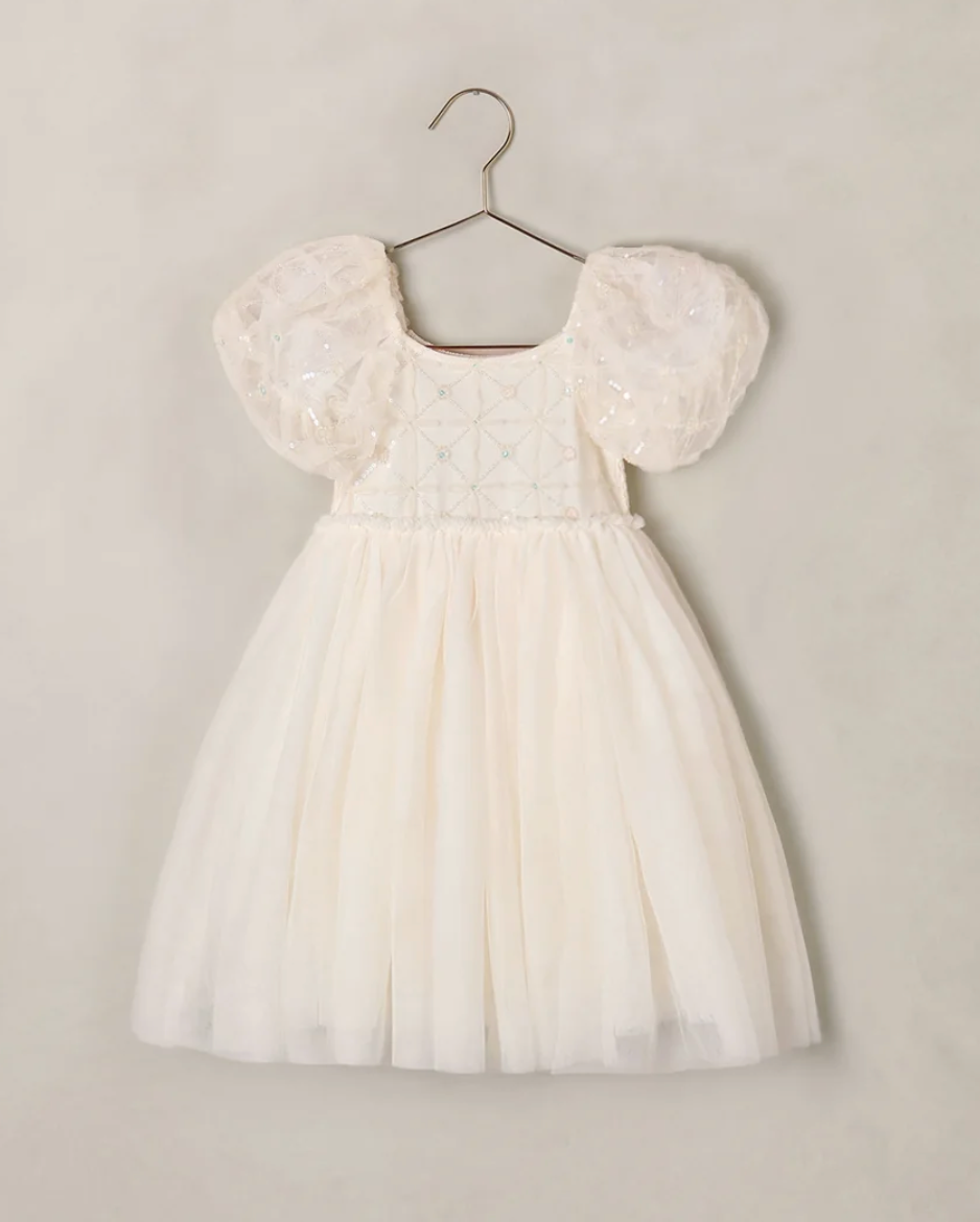 Ivory children's dress with puff sleeves, sequin bodice, and tulle skirt on hanger.