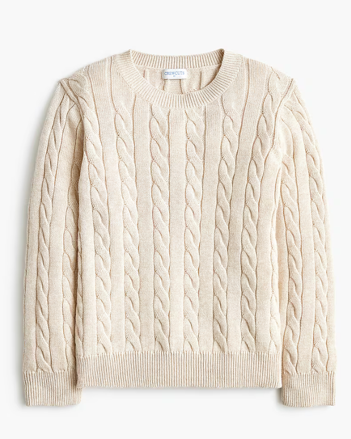 Cream cable-knit crewneck sweater with classic braided pattern and ribbed cuffs and hem.