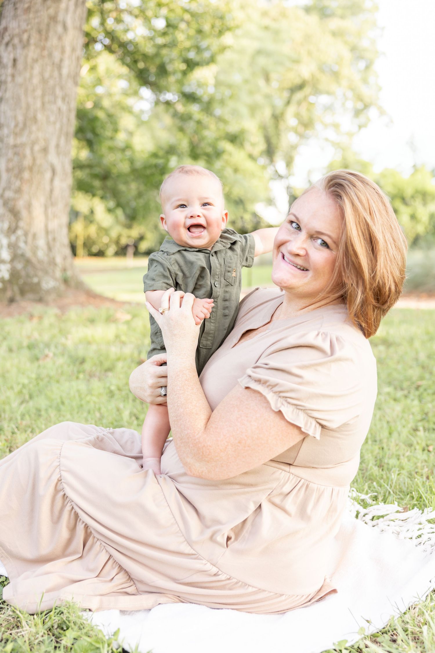 A mother and her son share a playful moment sitting outside on a blanket at their Columbus, GA family photography session.