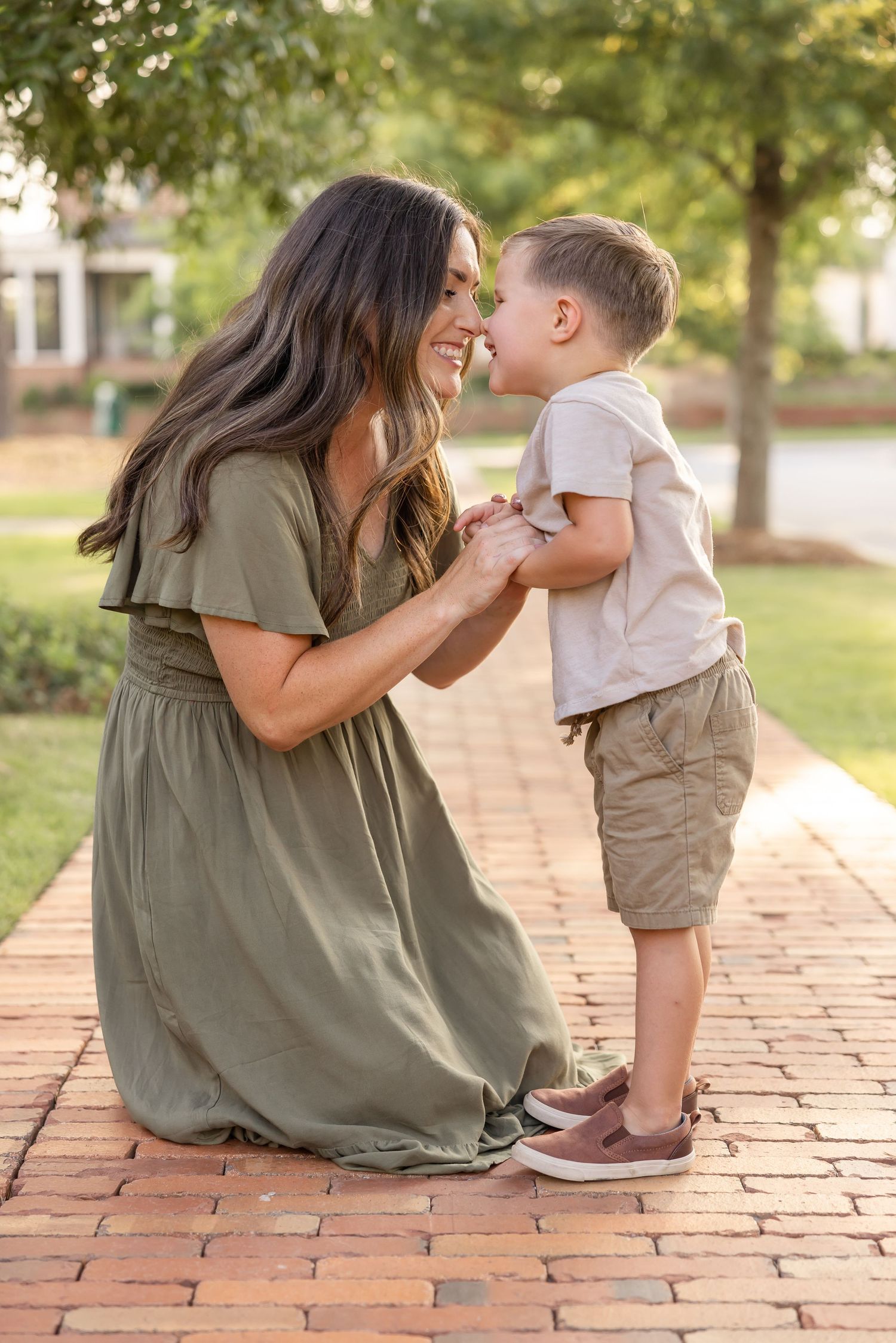 A tender moment between mom and son as they touch nose to nose and giggle at Old Town Columbus in Columbus, GA.