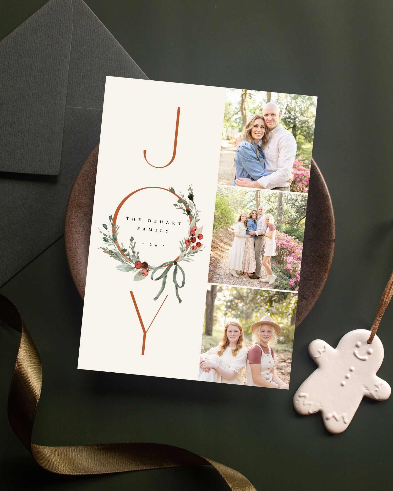 Images of a photo greeting card design with floral accents shown in various stages on a dark wooden table.