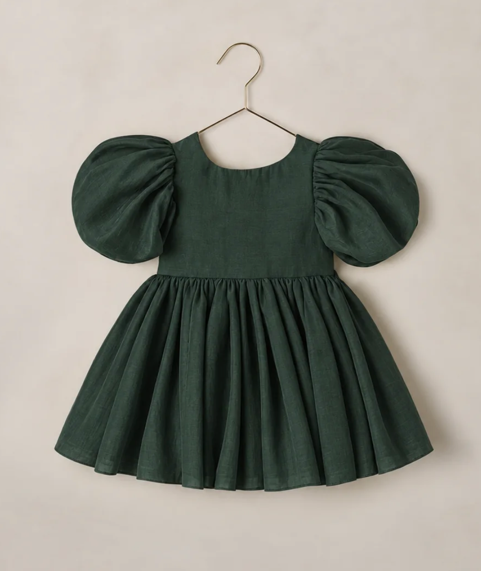 Dark green children's dress with puff sleeves and full skirt, displayed on a hanger against a neutral background.