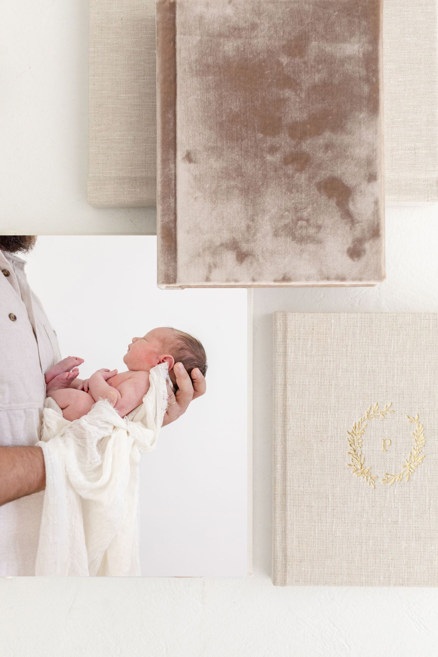 Elegant fine linen photo album collection with gold embossed details arranged in a minimalist style by Columbus, GA newborn photographer.