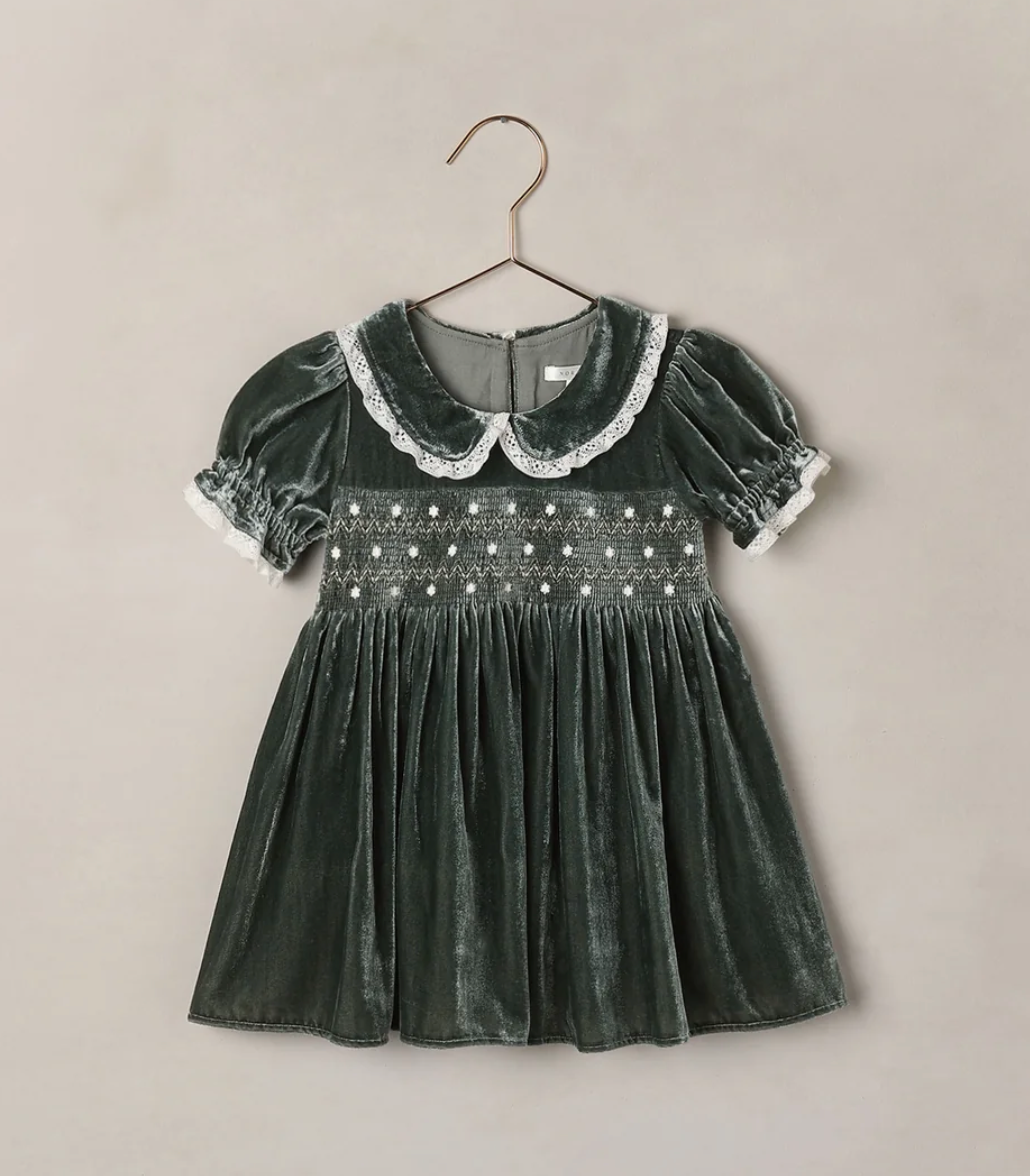 Green velvet smocked girls dress with lace collar and puff sleeves on a hanger.