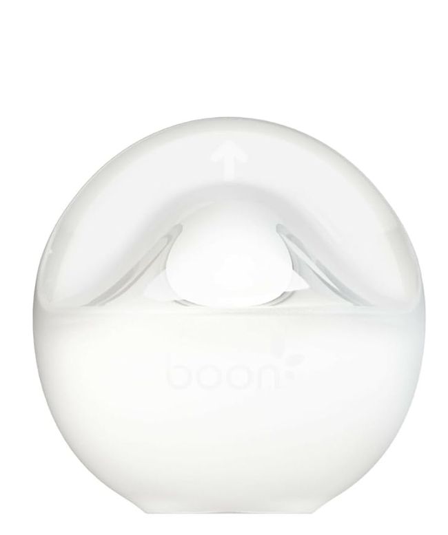 Multiple white ceramic donut-shaped napkin rings arranged in a row showing subtle surface variations and textures.