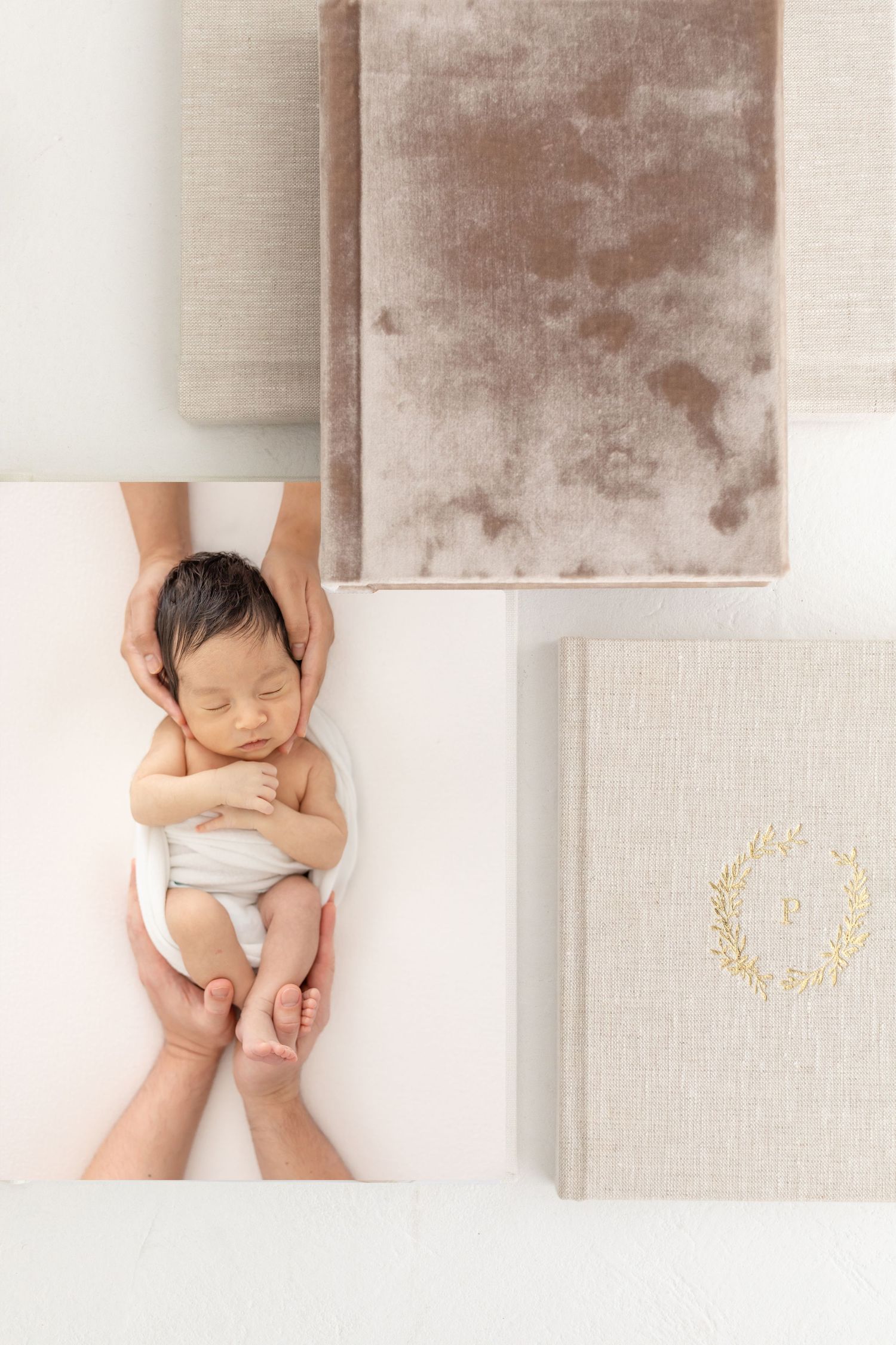 A sleeping newborn wrapped in white is gently cradled in hands against a white background at his Columbus, GA portrait session.