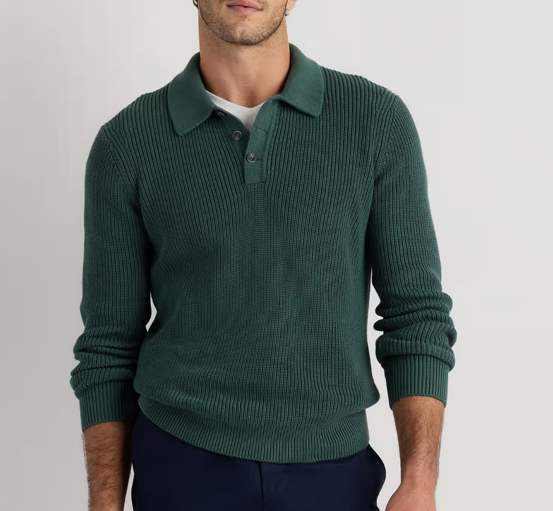 Men's green ribbed knit polo sweater with collar and button placket, long sleeves, worn with navy trousers.