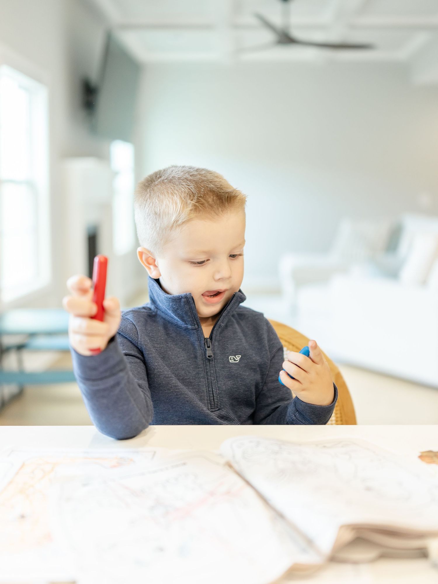 Young boy coloring at the table during his Columbus, GA lifestyle family portrait session.