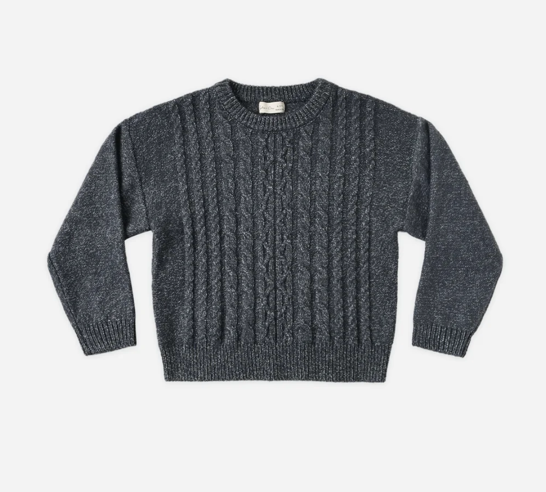 Dark gray cable-knit crewneck sweater with classic braided pattern and ribbed cuffs on white background.