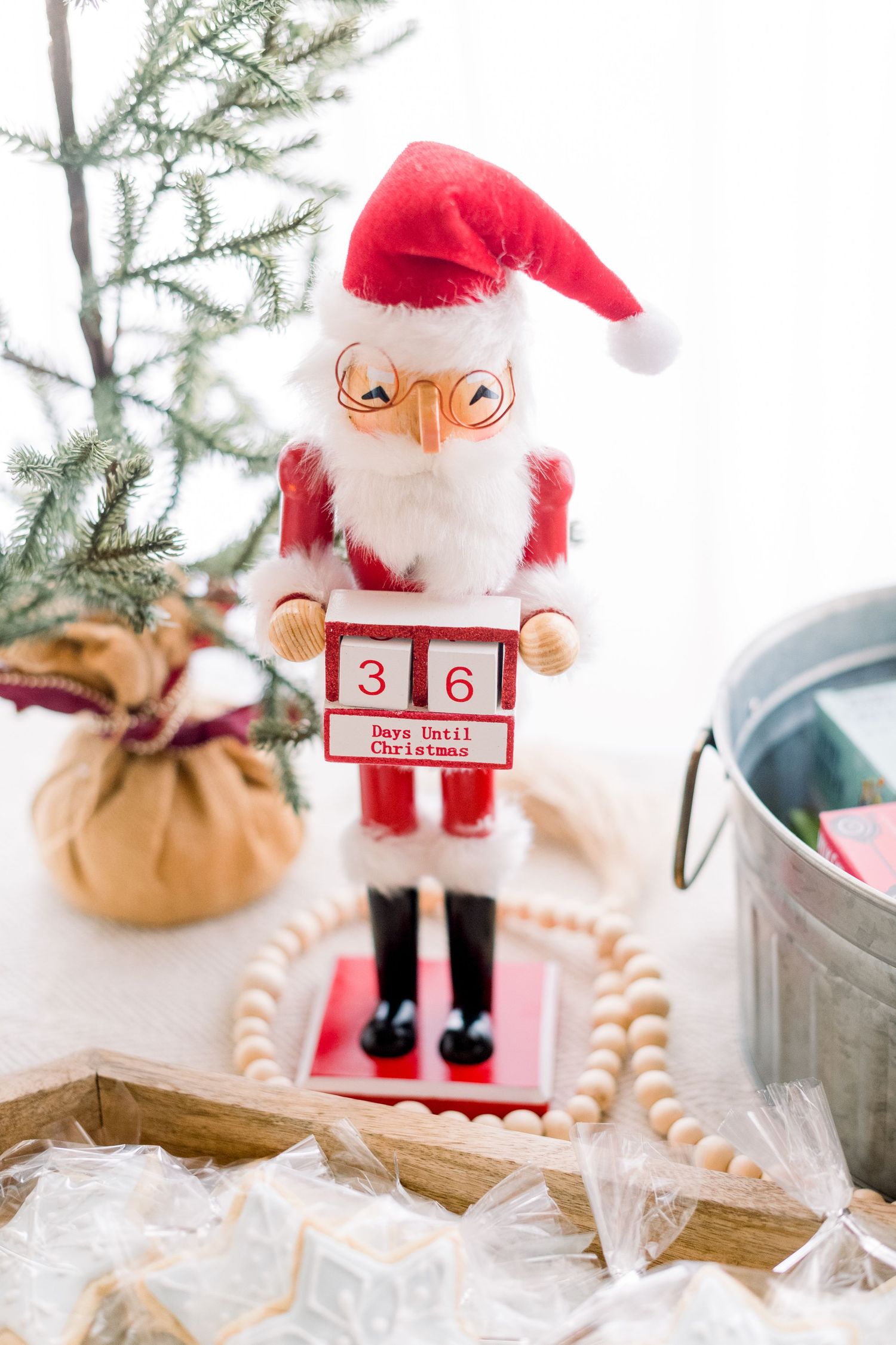 A festive Santa Claus nutcracker countdown calendar displaying 36 days until Christmas, surrounded by holiday decorations.