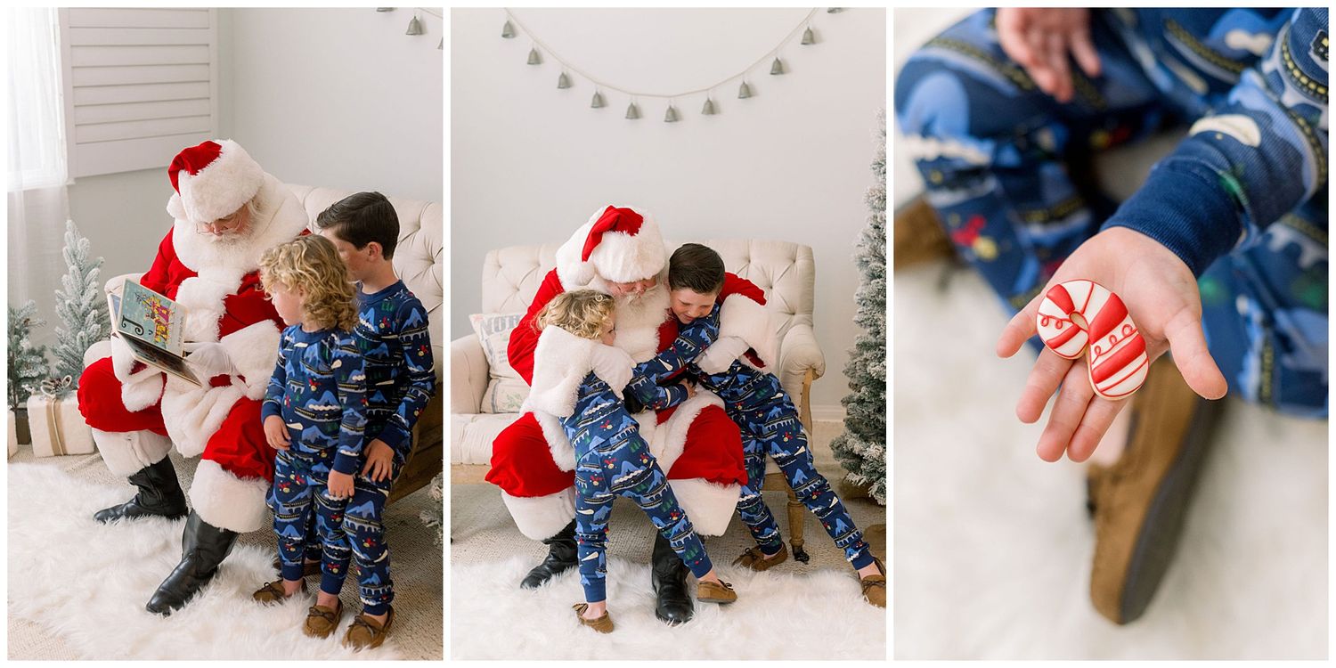 Two children in matching blue pajamas sit with Santa Claus during a cozy Christmas photo session on a white fur rug.