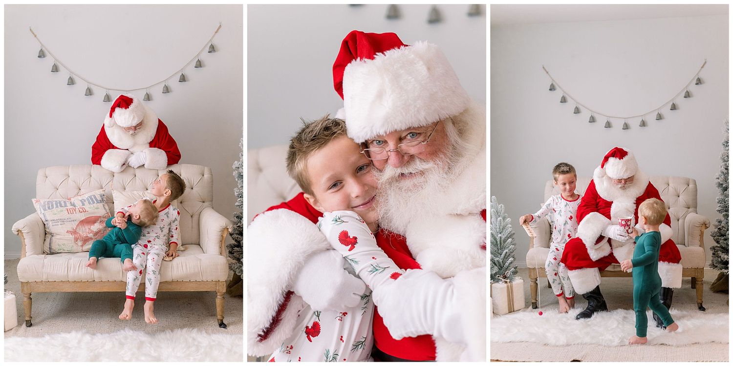 Children smile and hug Santa Claus during a festive holiday photo session with white studio backdrop and Christmas decor.