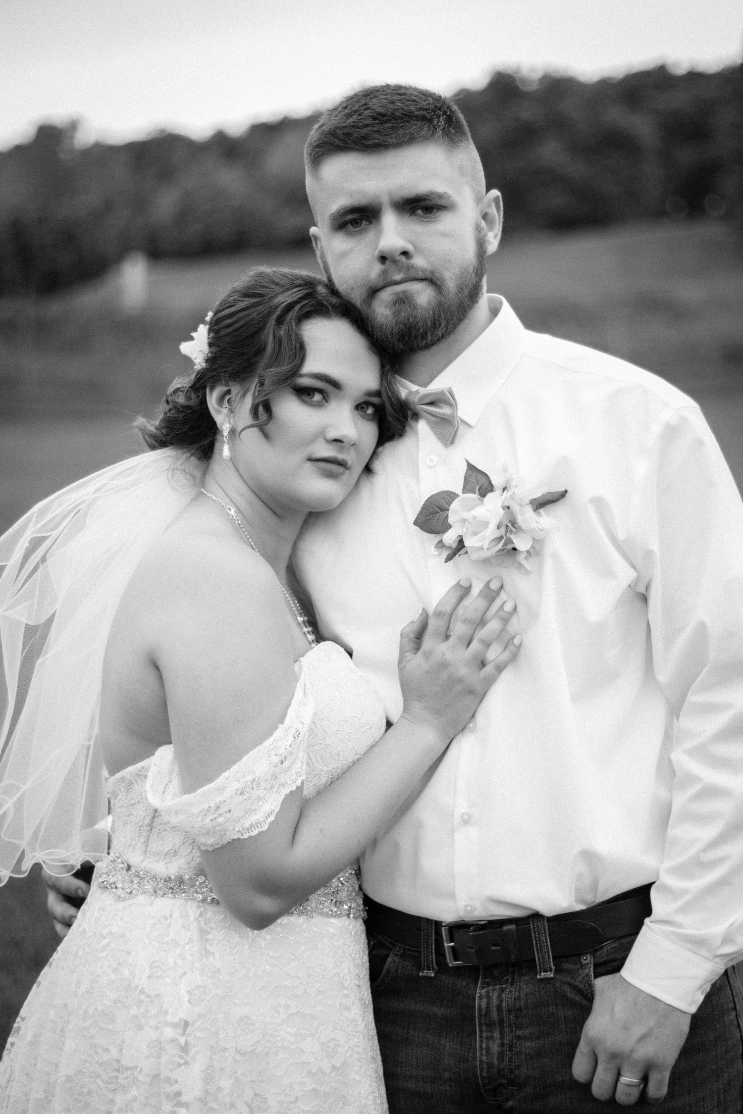 Black and white romantic wedding portrait showing tender embrace.