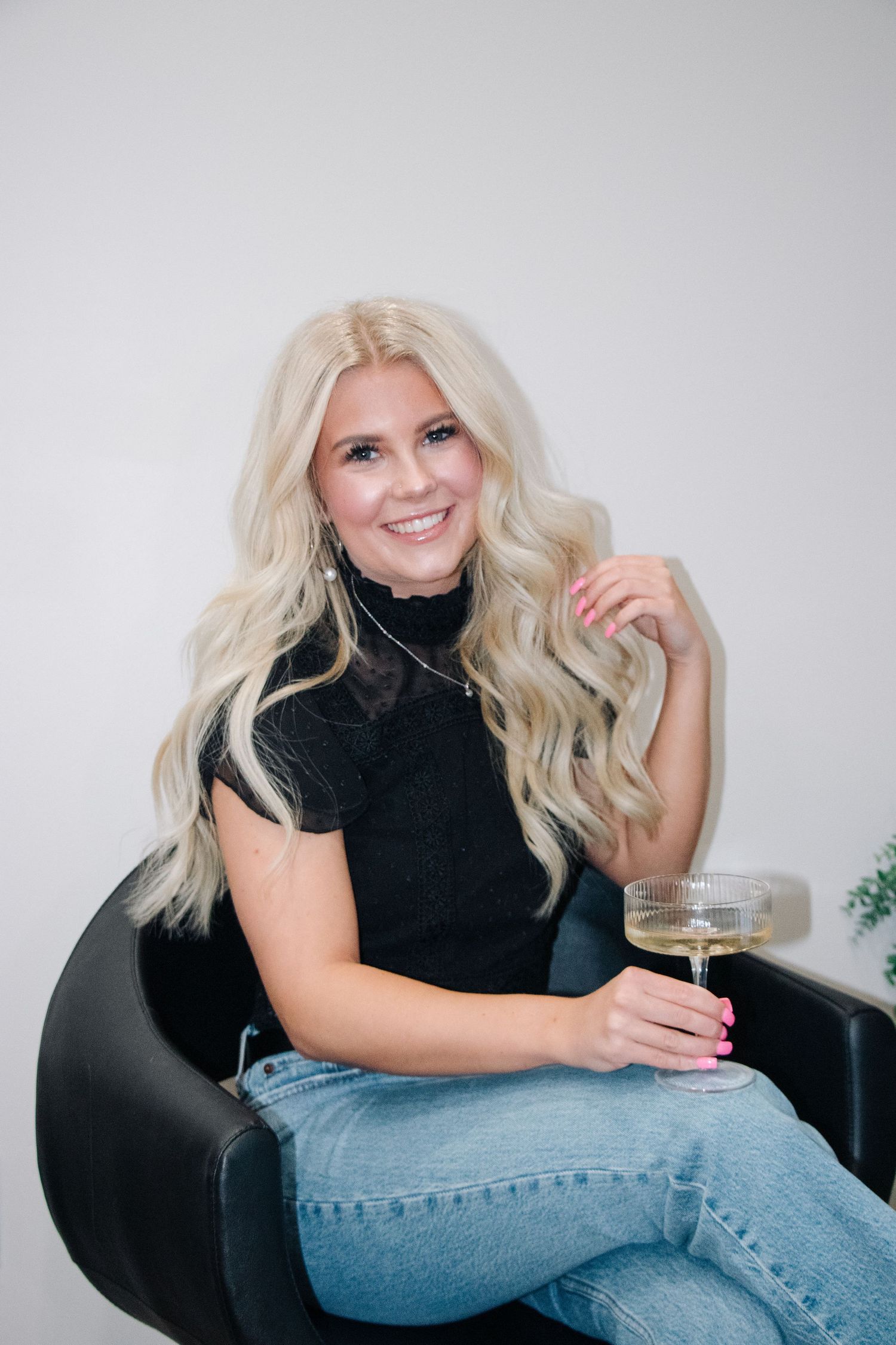 Casual salon branding session with champagne and black turtleneck.
