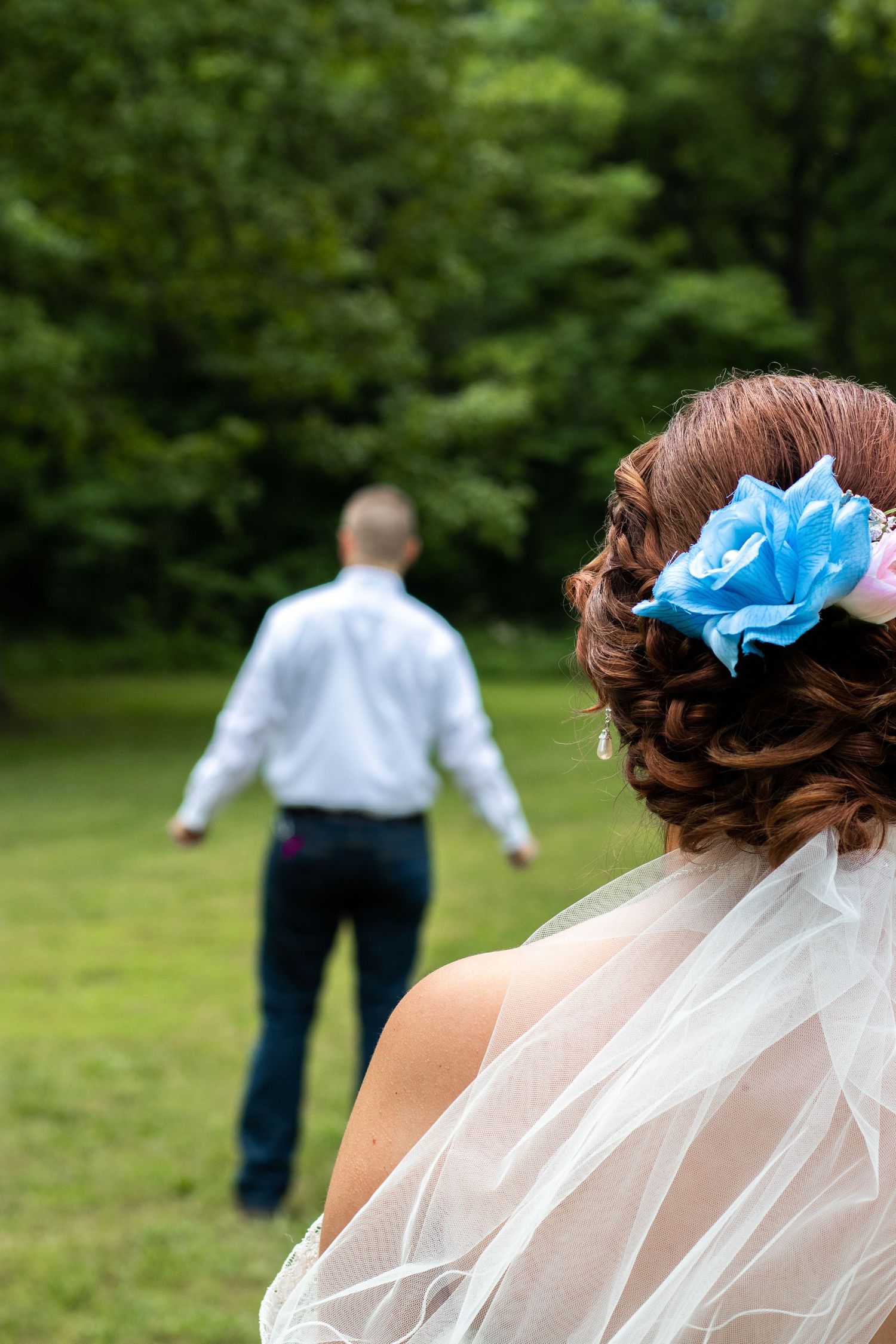 Wedding veil flows in the breeze during an outdoor photoshoot.