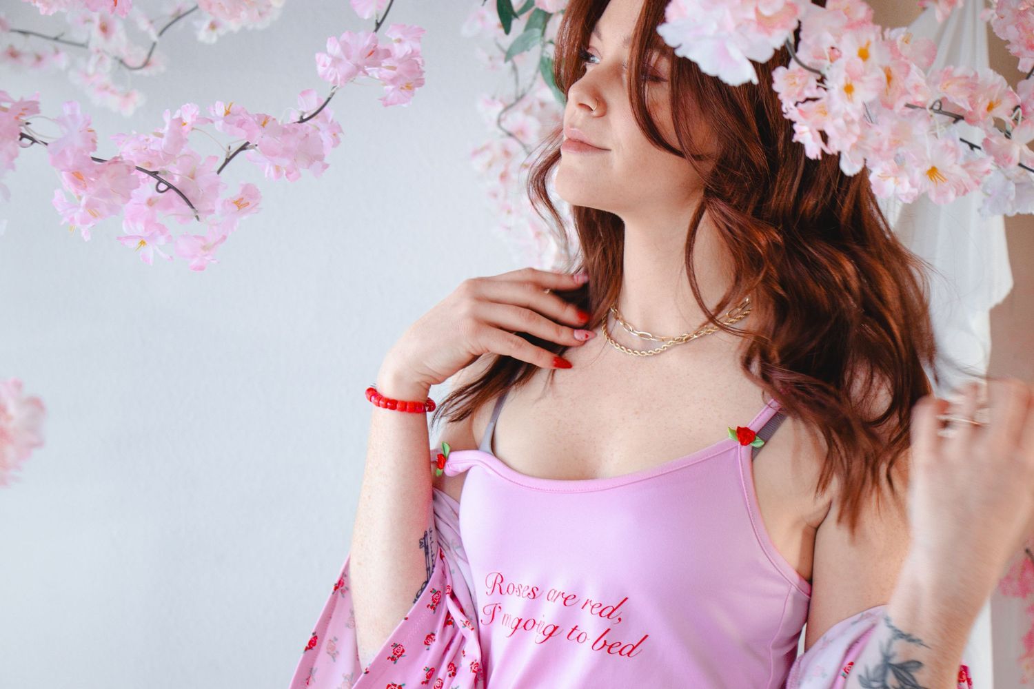 A dreamy spring portrait with pink cherry blossoms in the background.