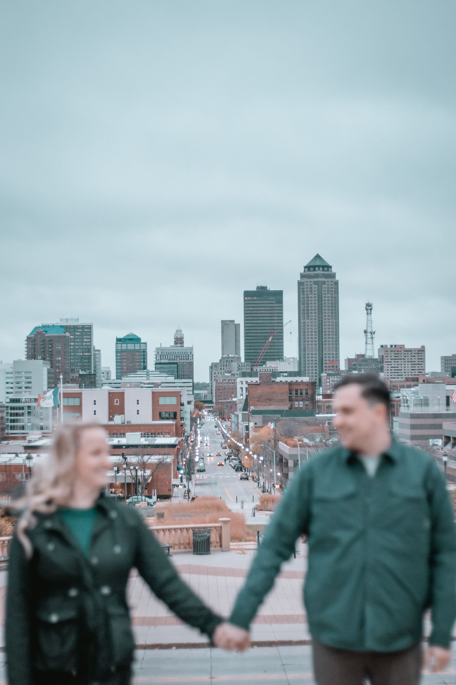 Progressive sequence of Des Moines skyline engagement photos with blurred foreground.