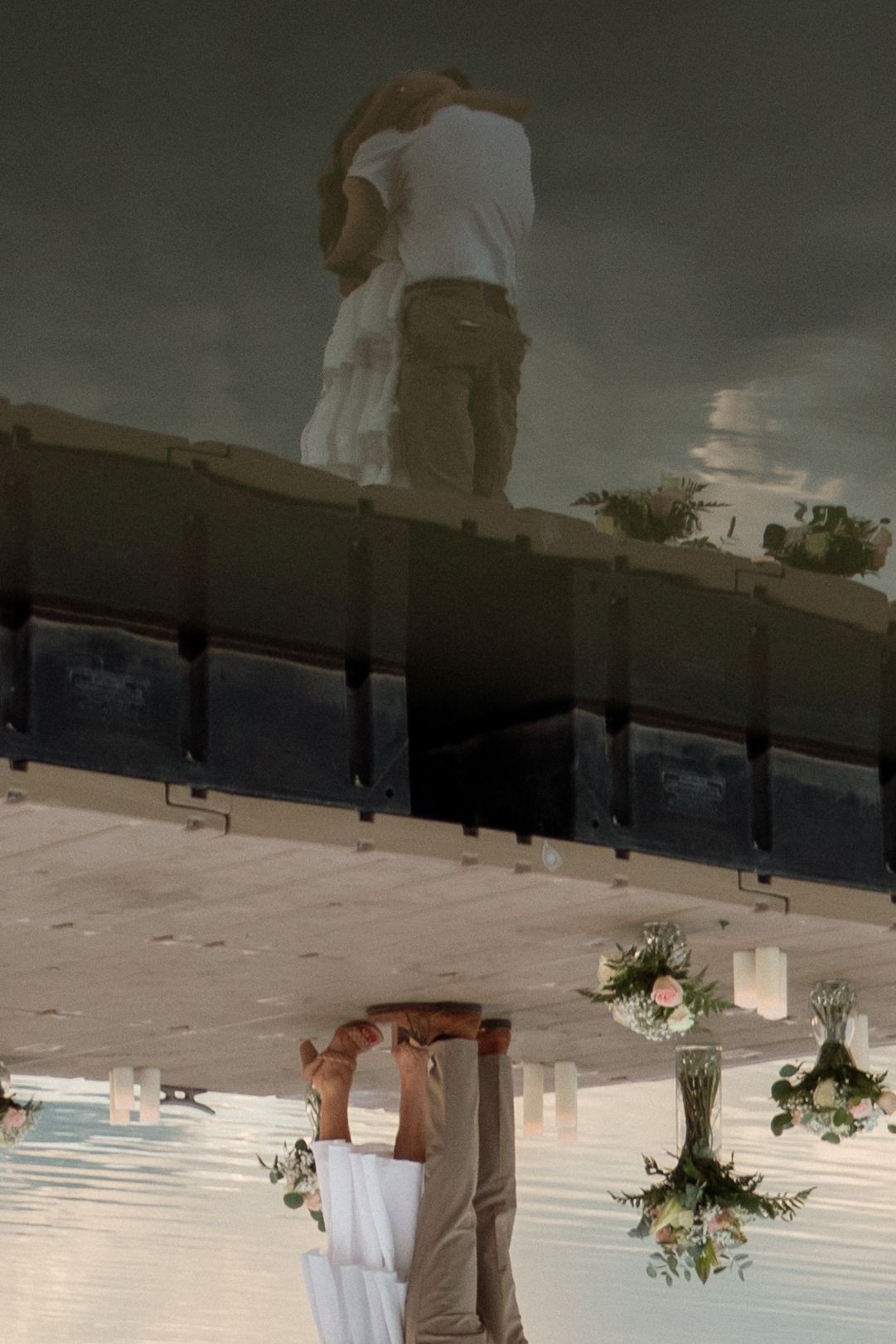 Wedding ceremony footage shows a ring bearer walking down an aisle with floral arrangements hanging from above.