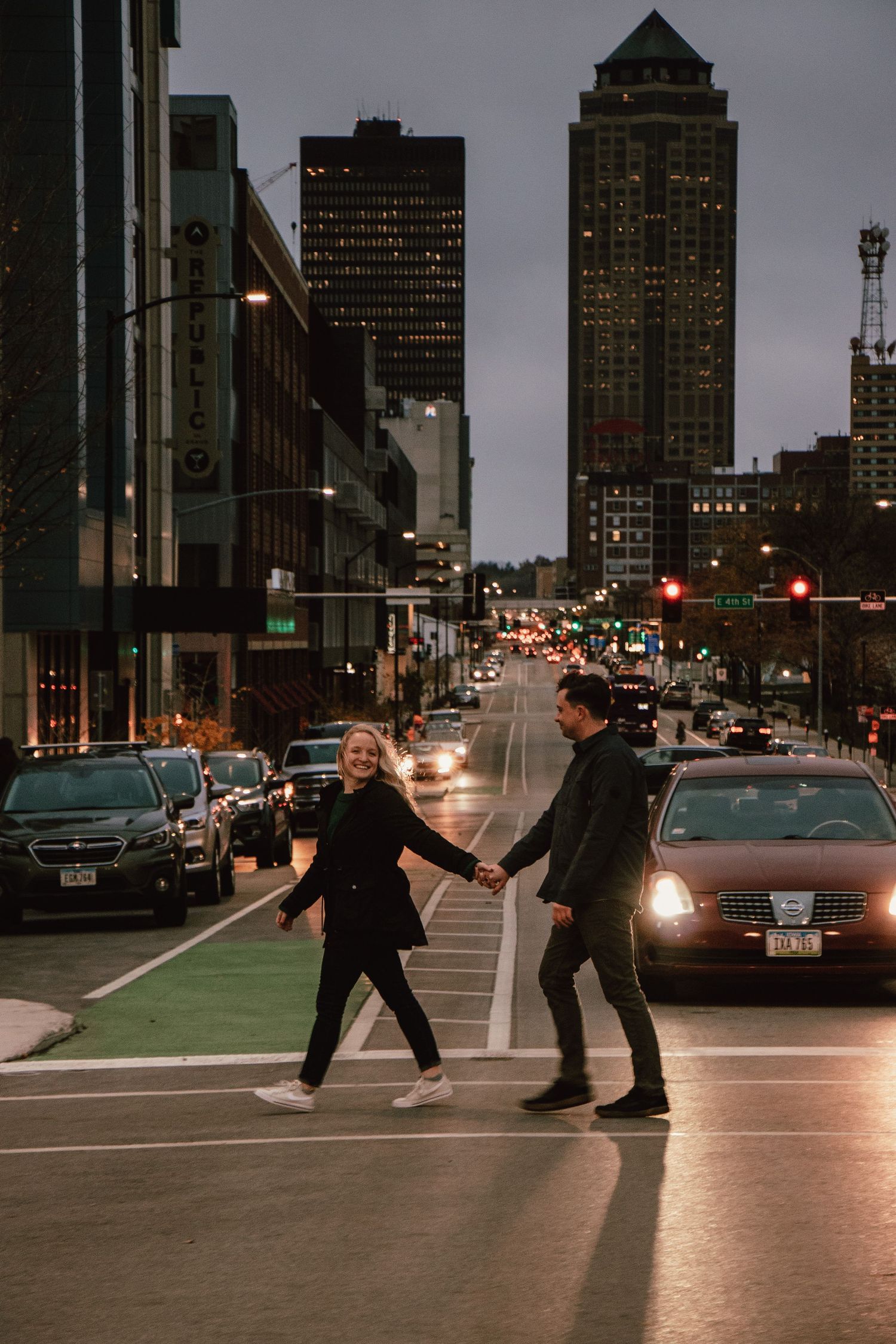 Urban nighttime engagement session with city lights and dramatic poses in downtown setting.