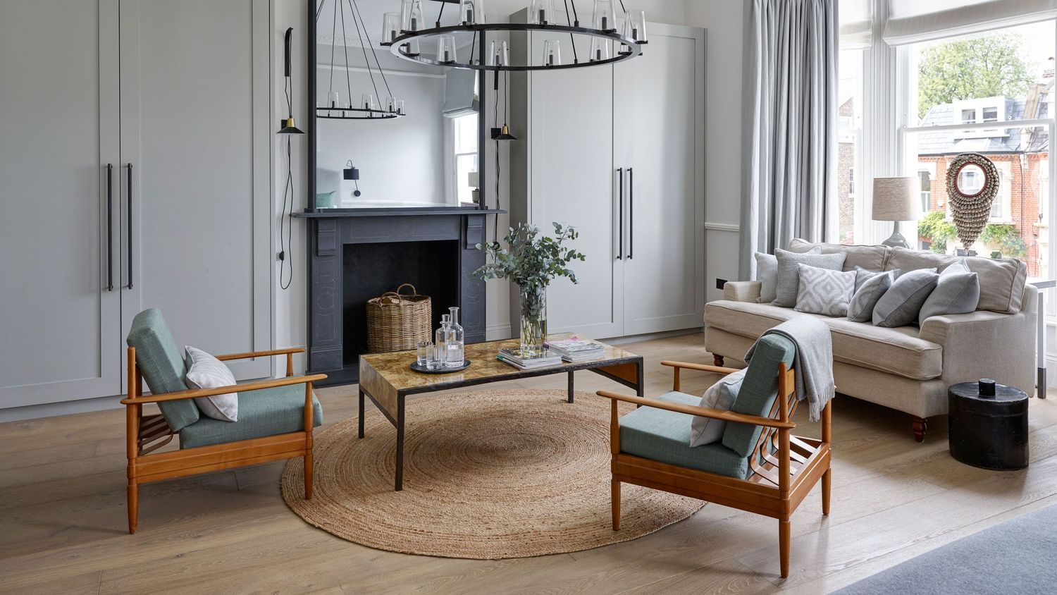 Modern Scandinavian interior design featuring minimalist furniture, white walls, and a circular jute rug in open living space.