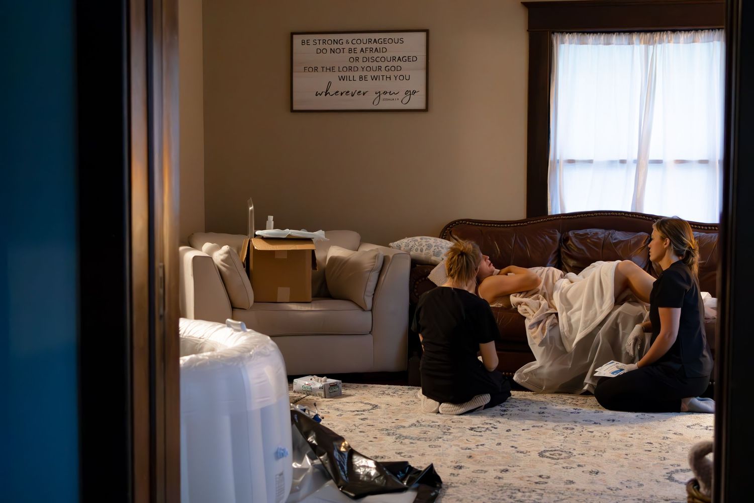 Peaceful home birth environment with soft lighting and comfortable furnishings.