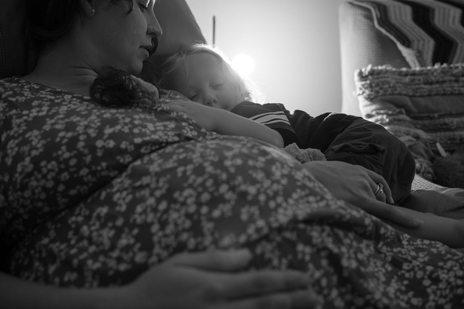 A series of black and white images showing someone resting in a hospital bed.