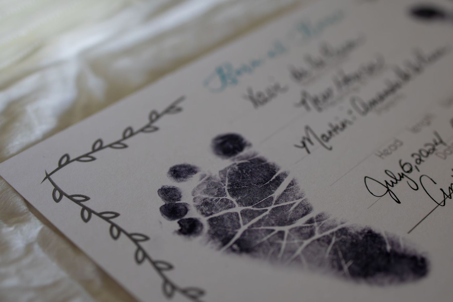 Tiny footprint impression made on medical documentation paper. Wichita newborn photographer in-home session