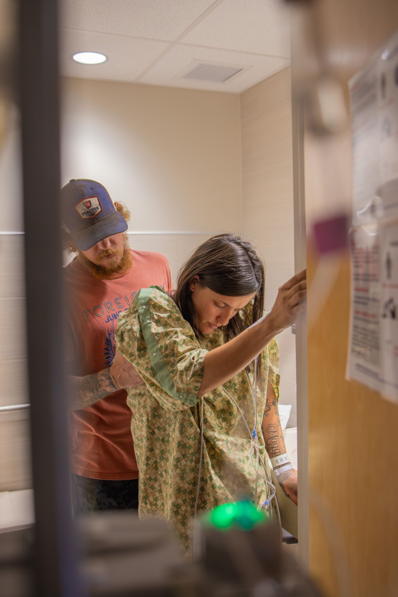 Hospital room scene showing medical staff and equipment with overhead lighting.
