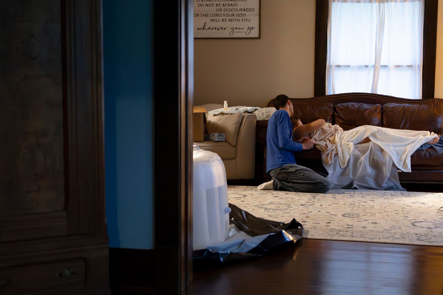 Quiet birthing space set up in home with natural light streaming through windows.