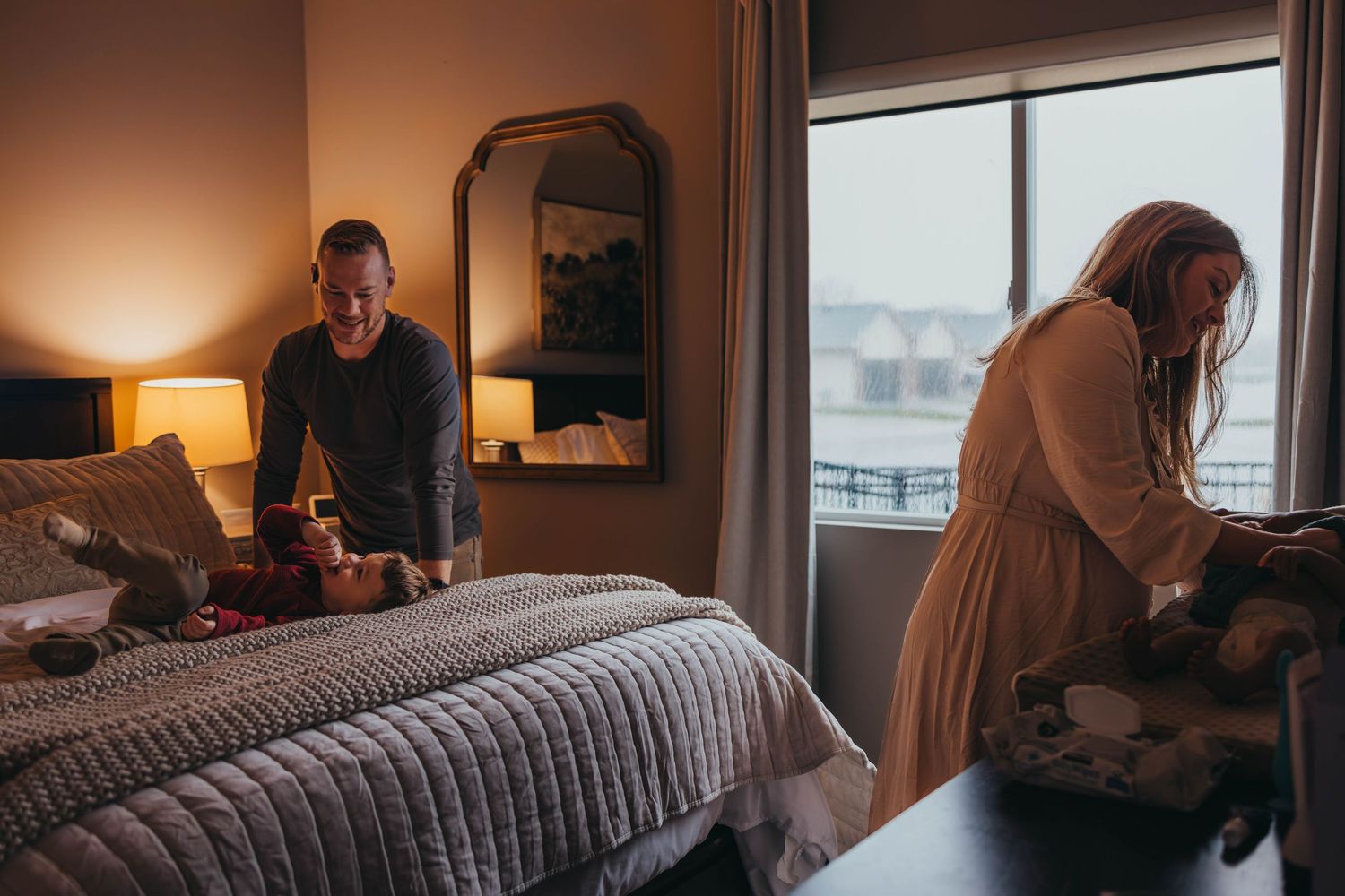 Cozy bedroom scene with soft lighting and window view.