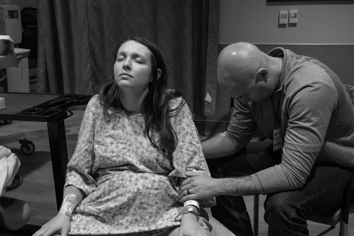 Black and white photo sequence showing emotional moments during labor and delivery in a hospital room.