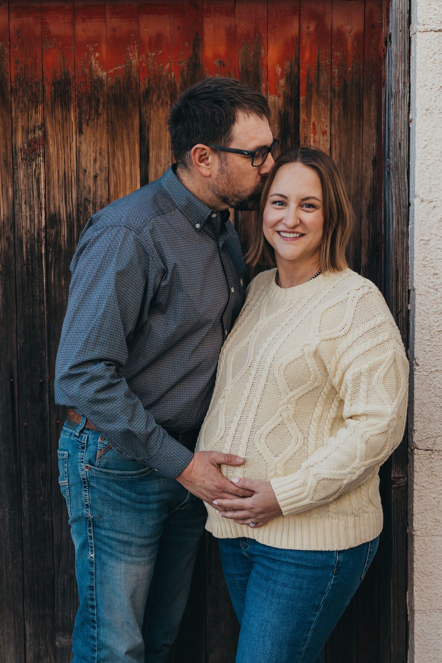 Romantic couple in casual attire share intimate moments against rustic wooden backdrop in four-photo series.