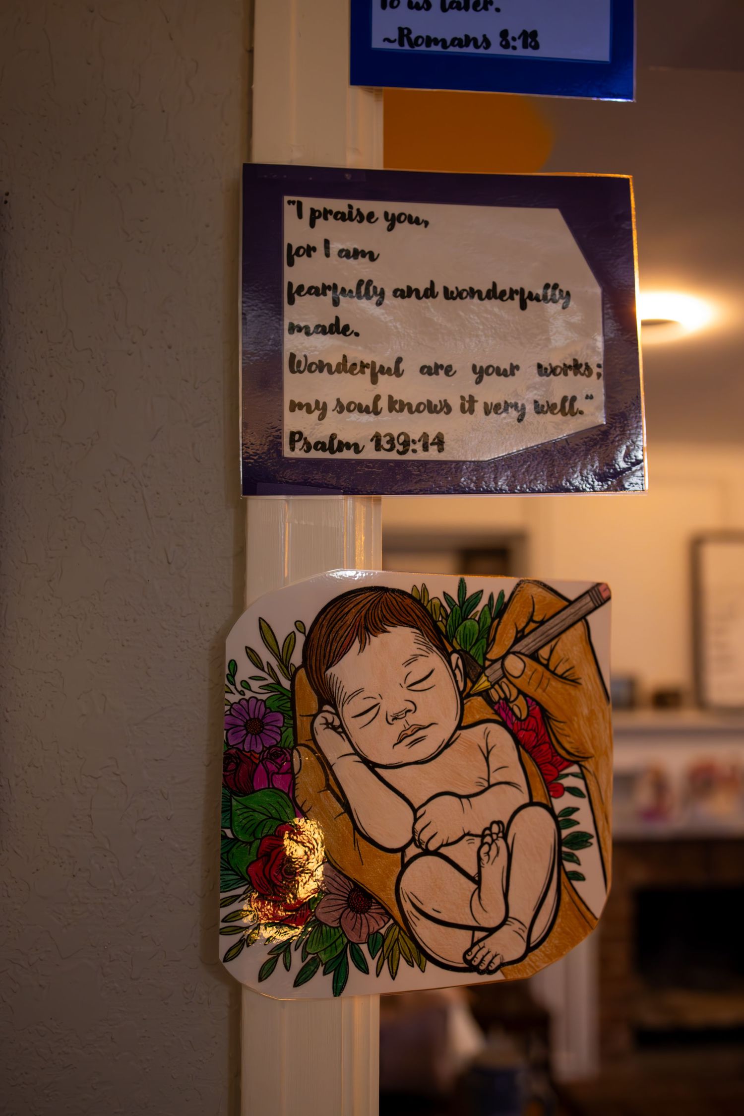 Decorative wall art featuring baby-themed illustrations and inspirational quotes. Birth photography in Wichita Kansas