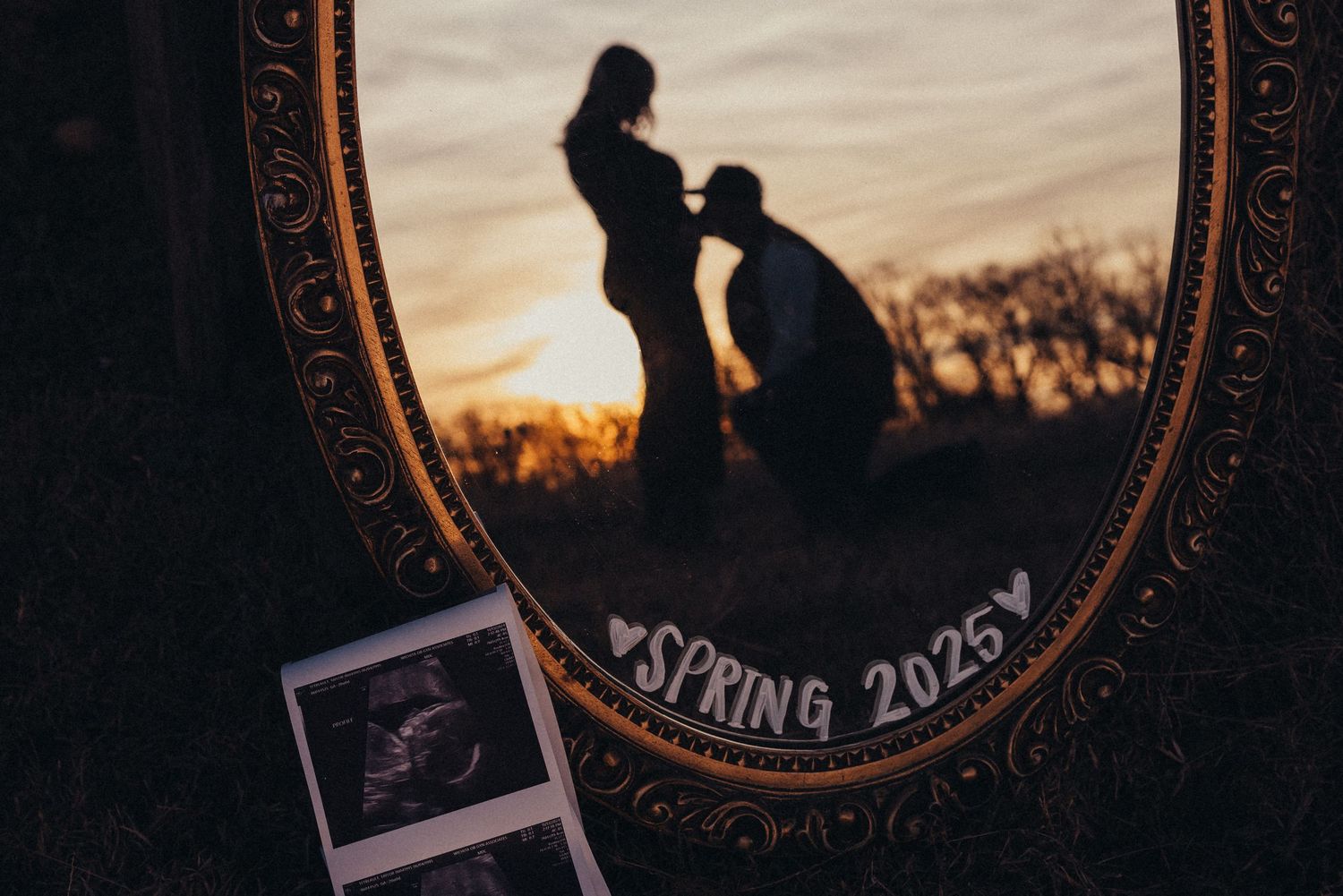 Vintage-framed ultrasound photo captured during sunset pregnancy announcement.