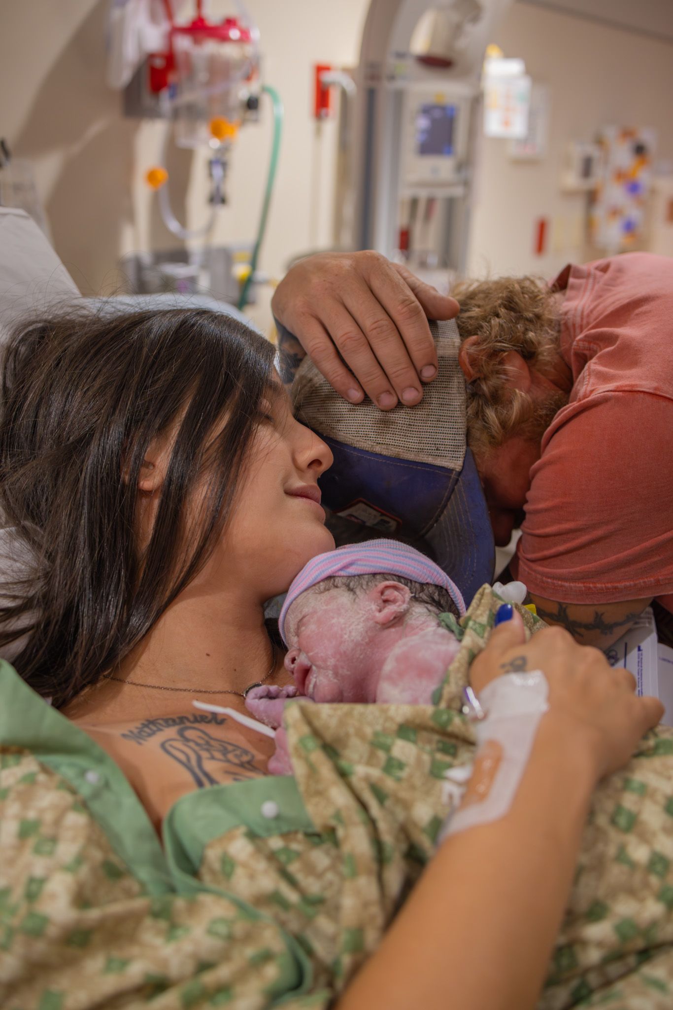 Hospital room scene showing patient care with medical equipment visible.