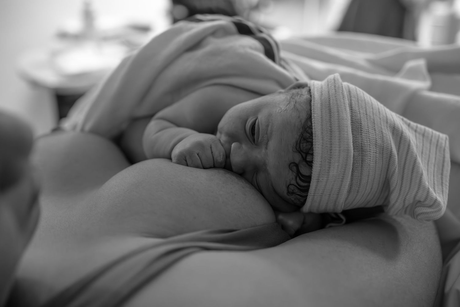 Black and white photographs showing tender moments between patient and care providers during delivery.