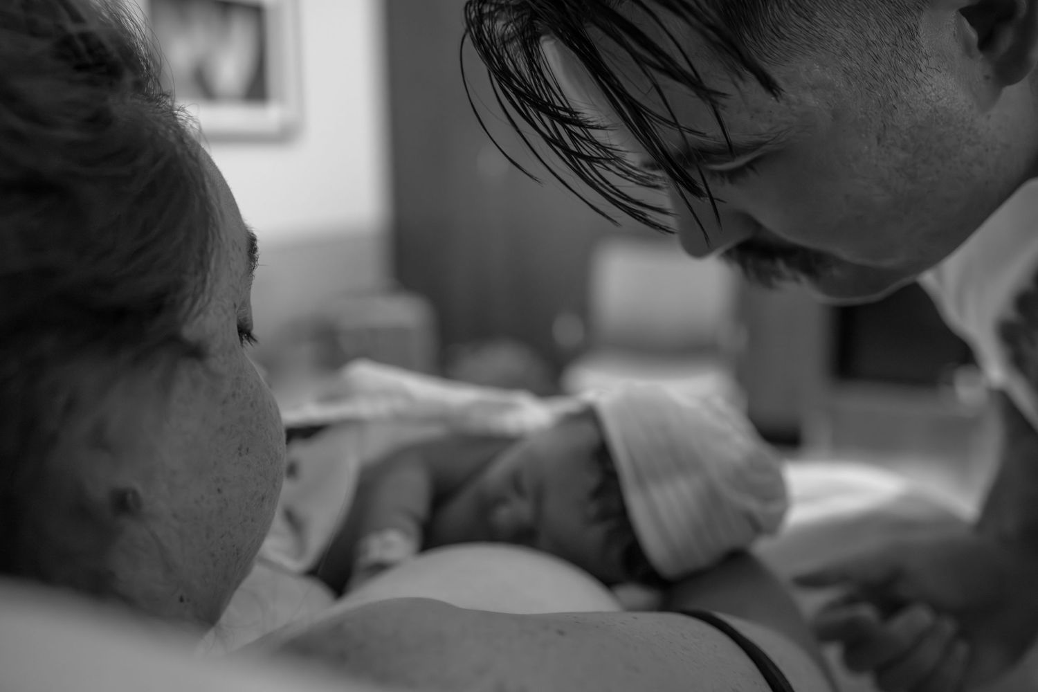 Healthcare providers working together in a hospital room during a procedure. Birth photography in Wichita Kansas