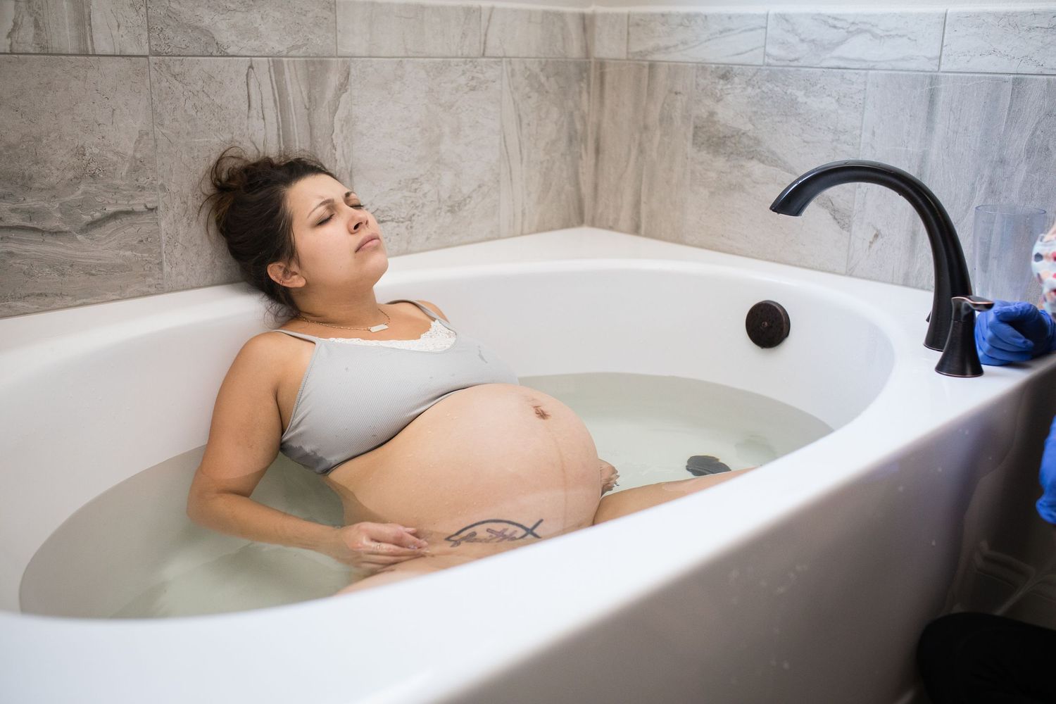 Peaceful moment captured of a pregnant woman in a soaking tub.
