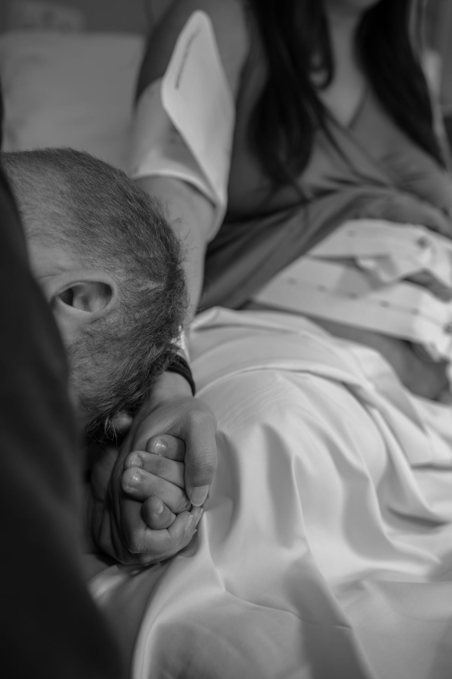 Black and white image of a newborn baby receiving medical care.