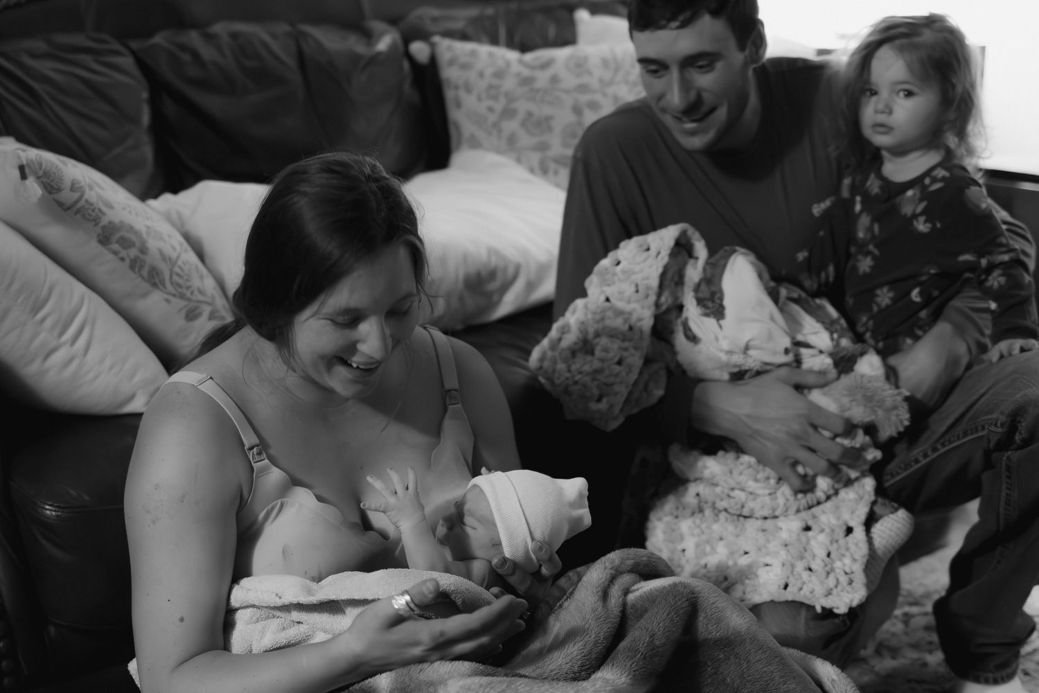 Woman in labor receives support during natural childbirth at home.