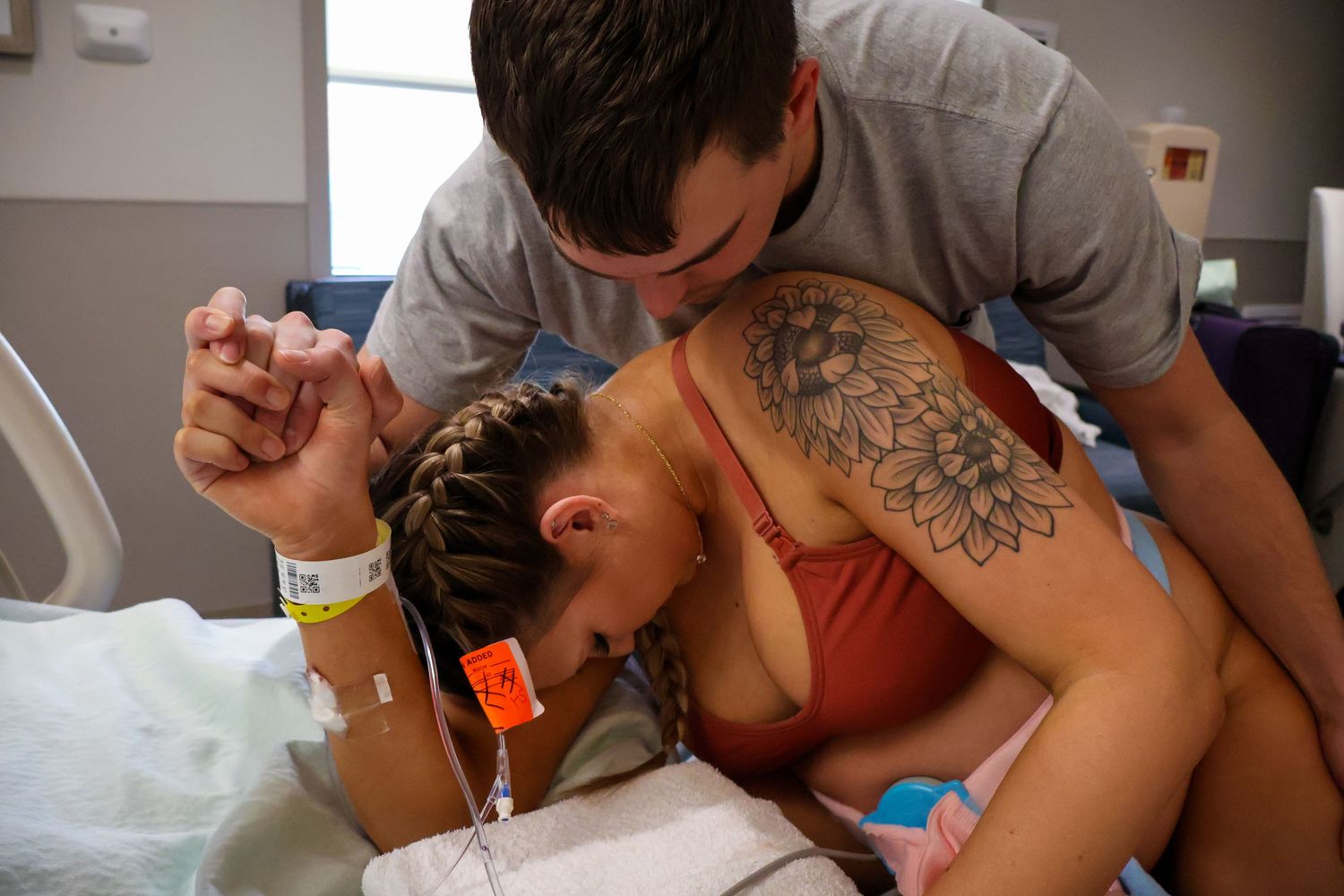 Medical professionals attending to patient during hospital delivery.