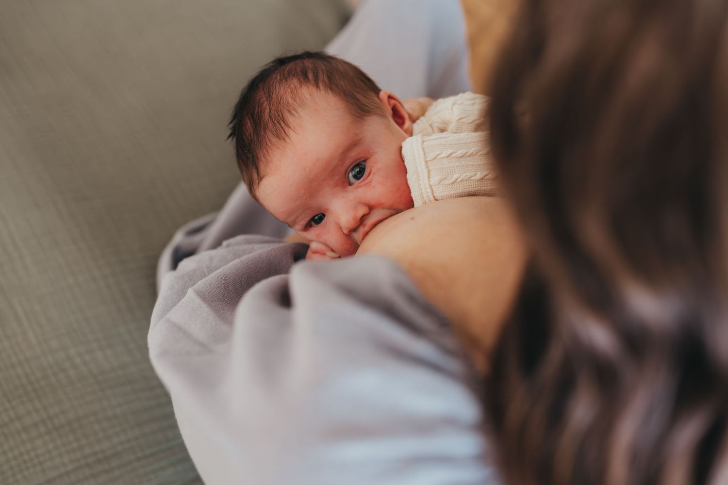 A series of tender moments showing a baby being held and comforted. Wichita newborn photographer in-home session