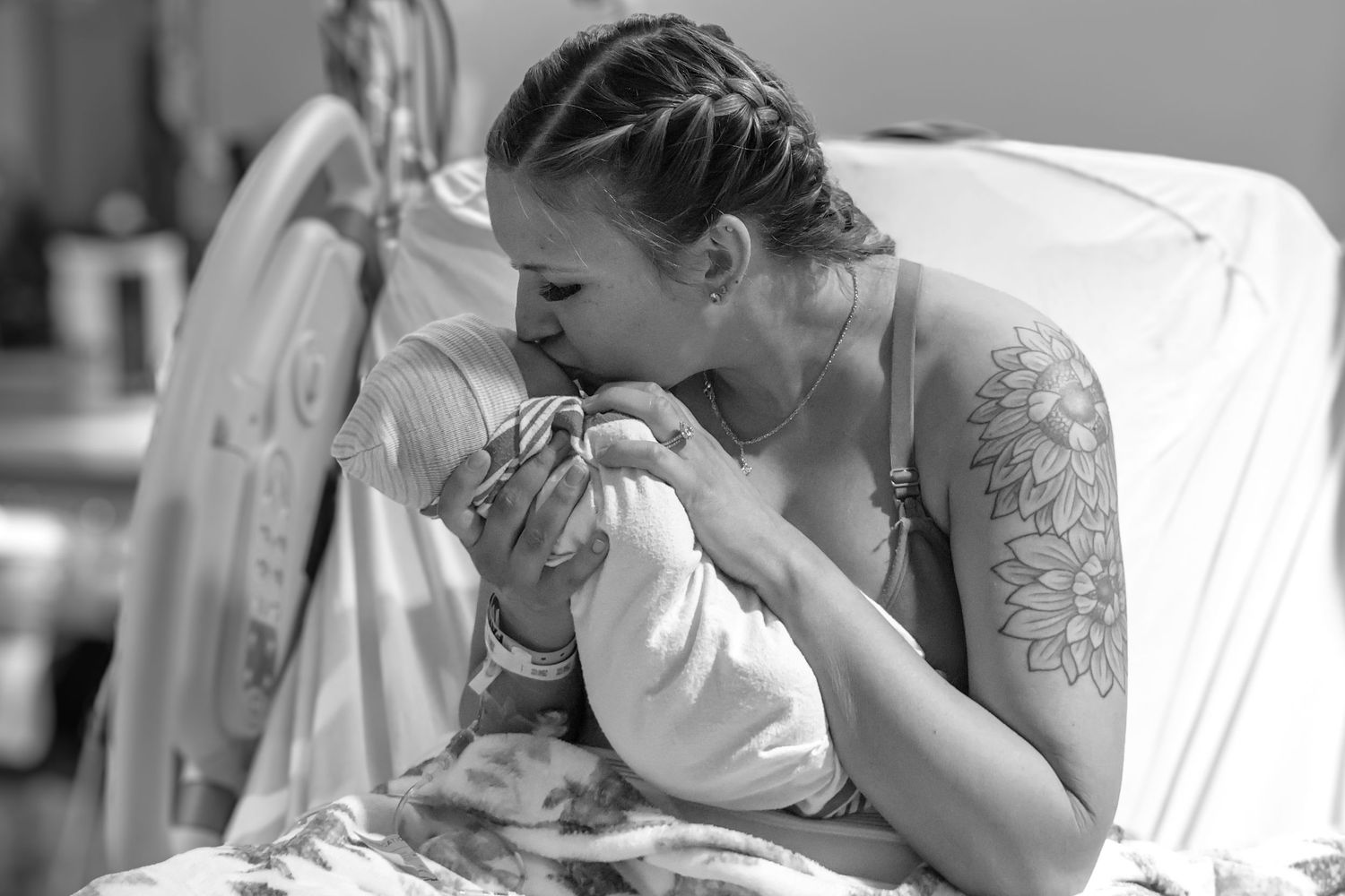 Emotional black and white images capturing moments during hospital childbirth.