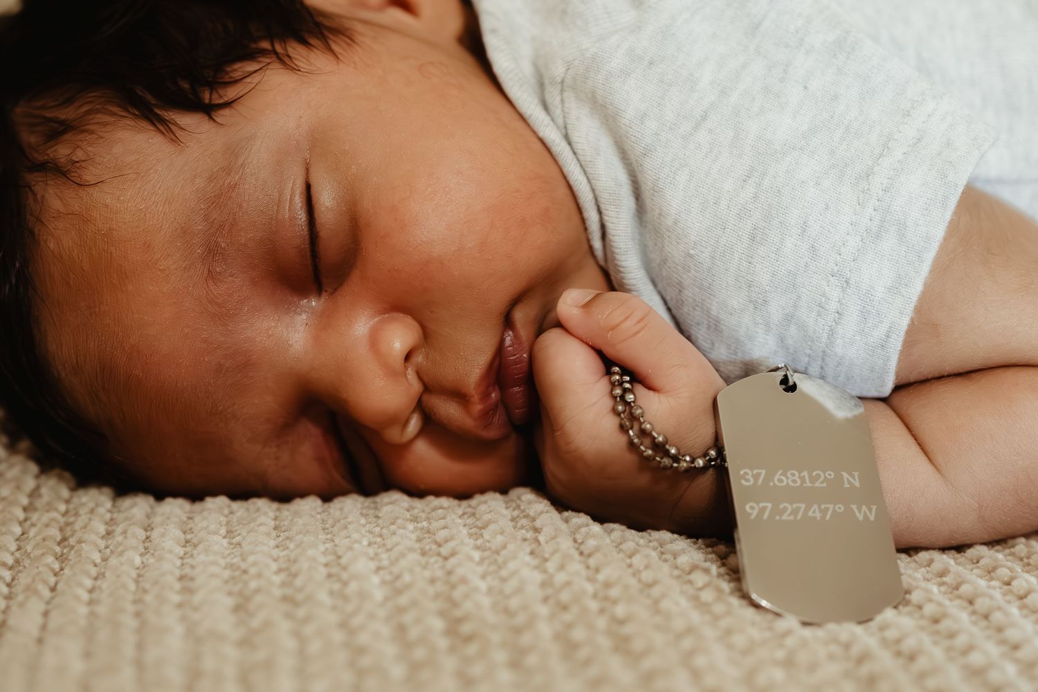 Peaceful sleeping infant resting on soft white bedding.