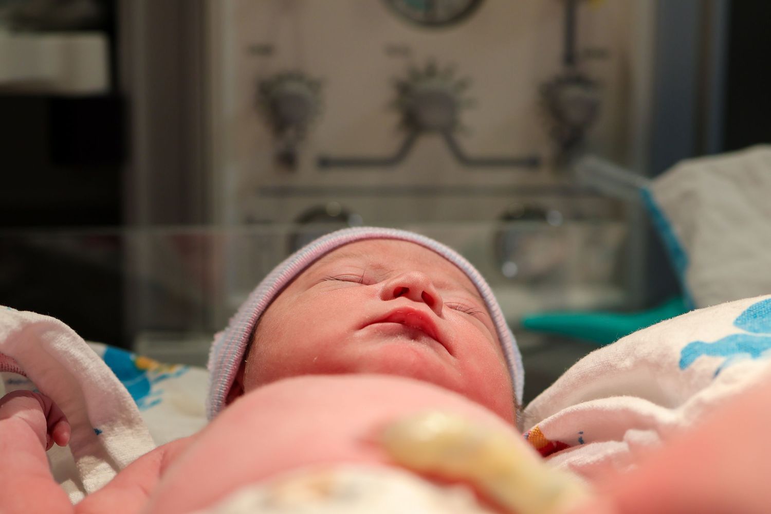Newborn baby receiving initial medical care in hospital setting.