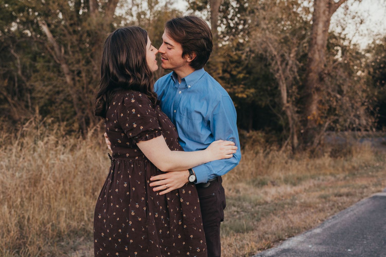 Romantic couple embracing and dancing on country road. Wichita, Kansas Maternity Photography