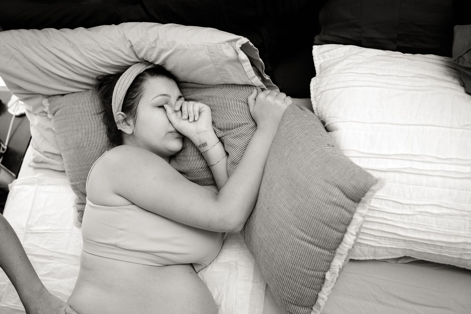 Intimate black and white photo of couple during labor at home.