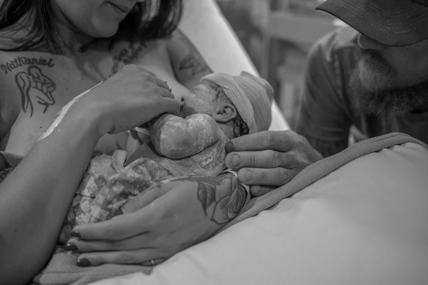 Black and white photograph showing a person resting in bed during labor.