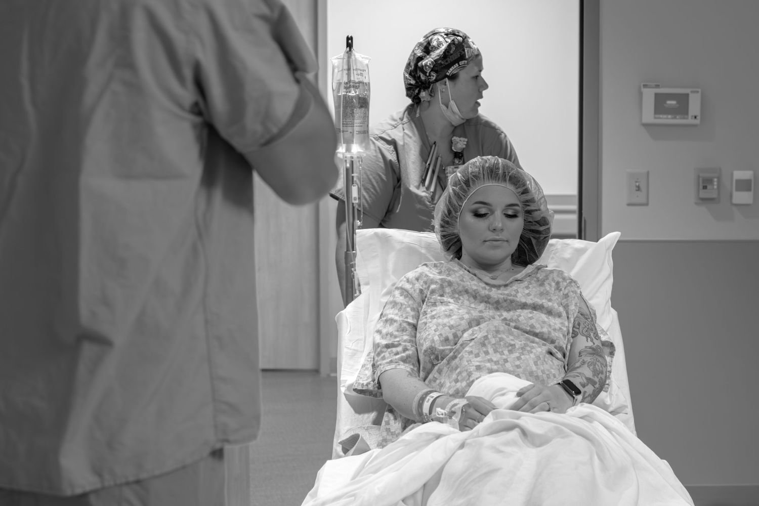 Series of black and white photographs documenting stages of labor and delivery in a hospital room.