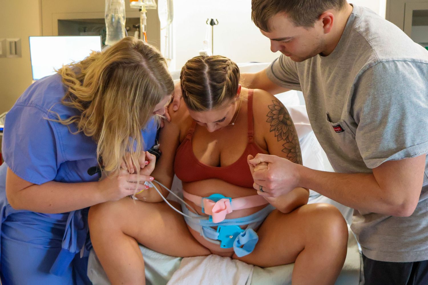 Medical staff providing care and support during labor in hospital setting.